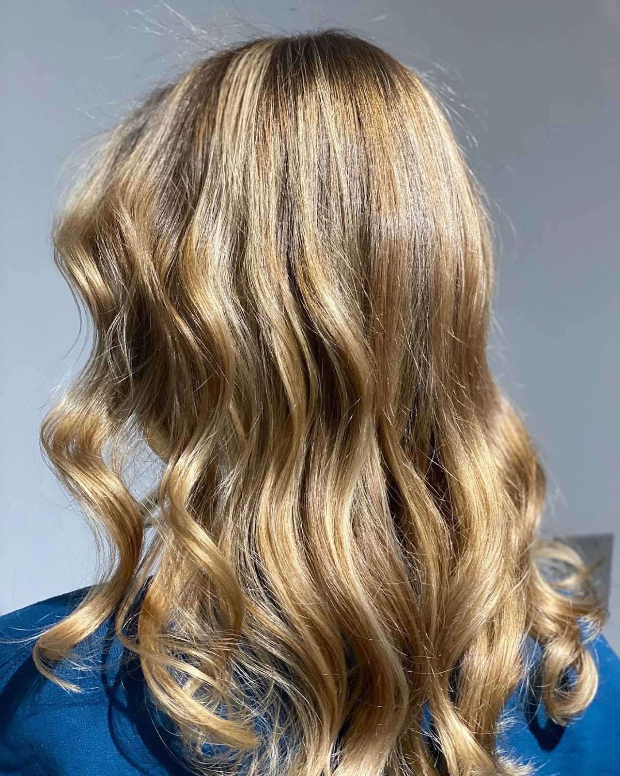 Blonde wavy hair against a light background.