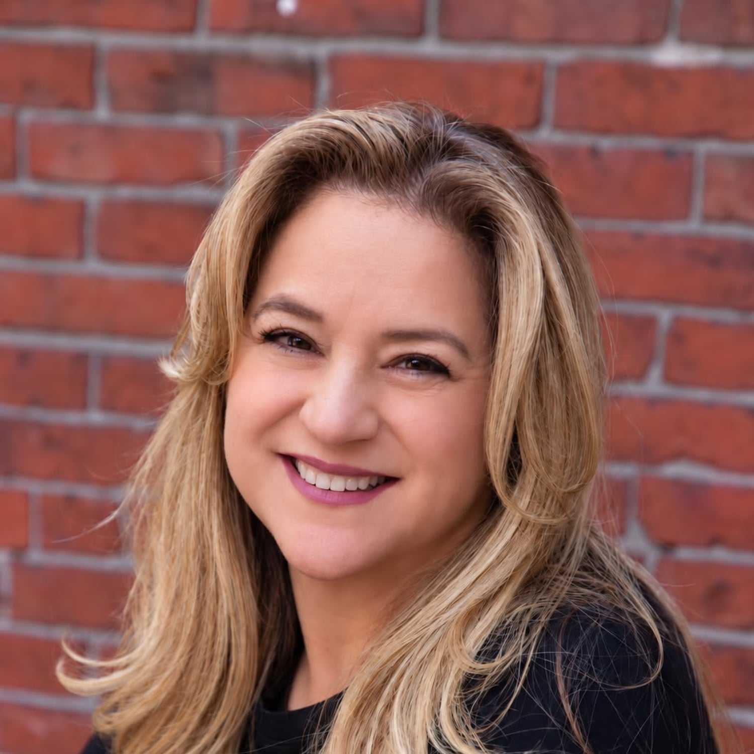 Portrait of Monica Rovaldi, a professional stylist at Luxor Hair Studio, showcasing their expertise and style.